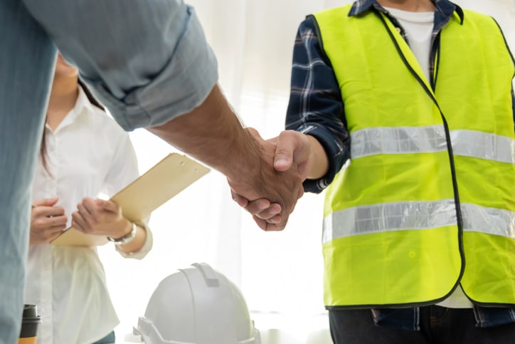 partner handshake at construction site